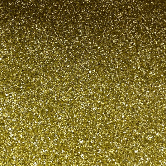 A close-up image of gold fine eco glitter, showing a dense, sparkling gold texture.