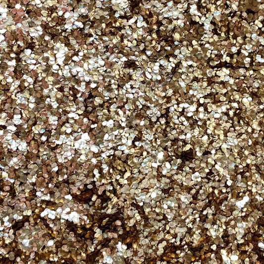 Close-up of rose gold chunky eco glitter showing the texture and reflective properties.