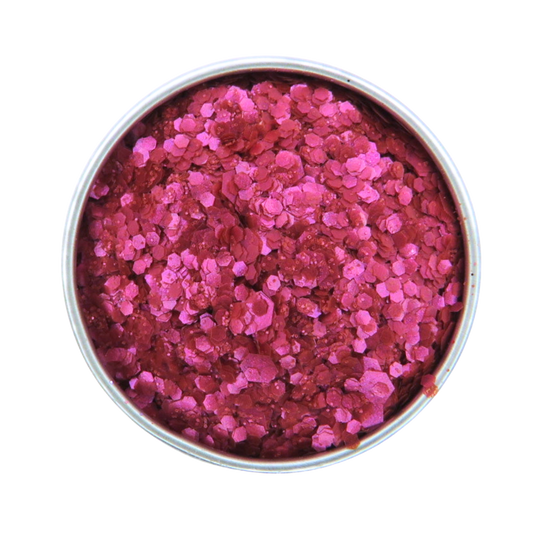 Pink glitter in a round container on a white background