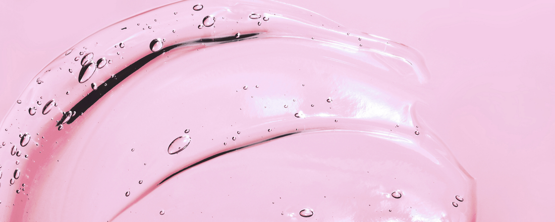 A pink background with a clear gel smeared across it