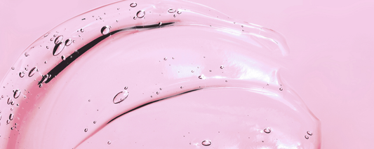 A pink background with a clear gel smeared across it