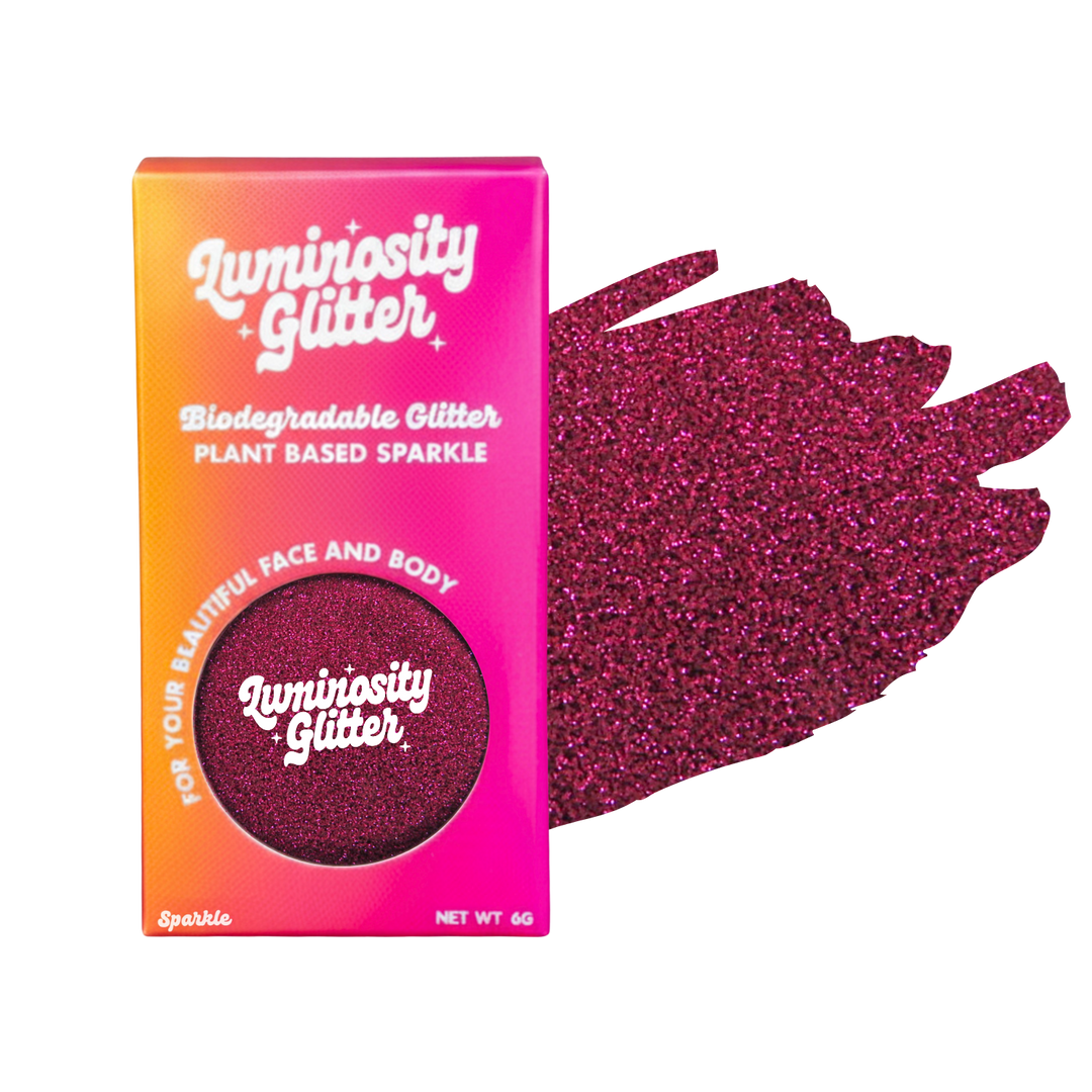 Luminosity Glitter packaging with pink and orange gradient and glittery purple sample.