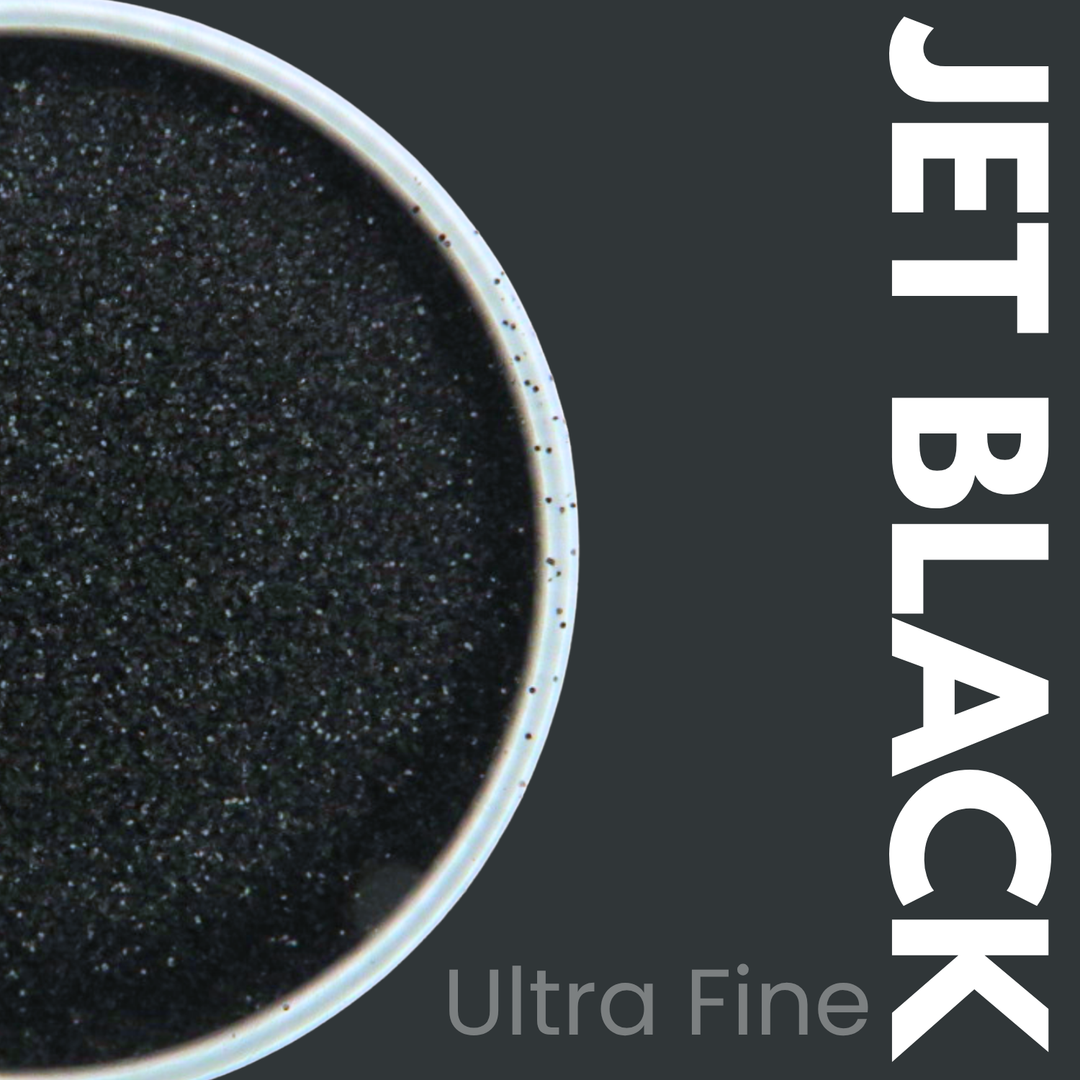 Ultra fine jet black glitter powder in a container with &
