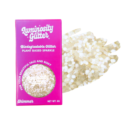 Biodegradable glitter packaging with glitter on a white background