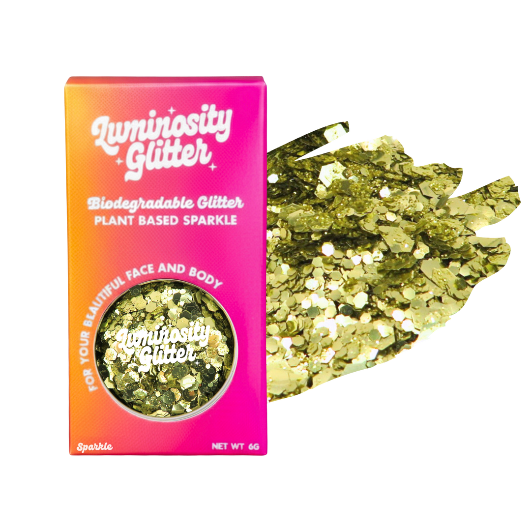 Luminosity Glitter packaging with gold glitter on a white background
