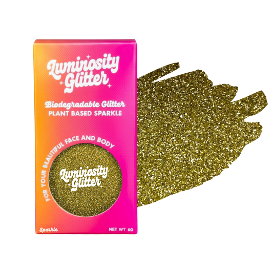 Luminosity Glitter packaging with gold glitter on a white background