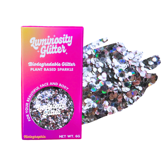 Biodegradable glitter packaging with holographic glitter on a white background
