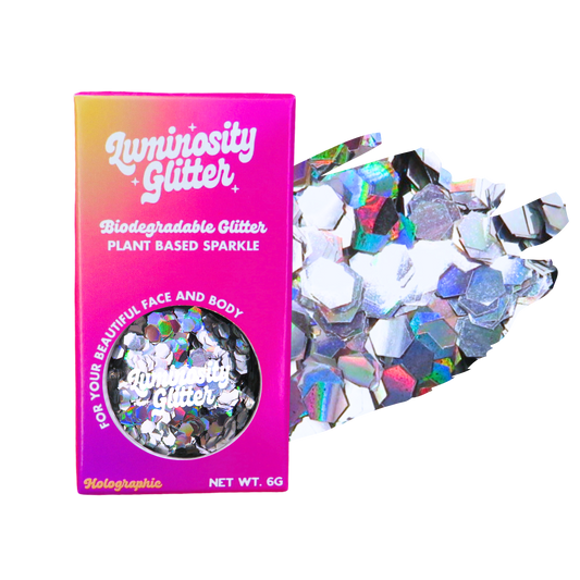 Biodegradable glitter packaging with holographic glitter on a white background