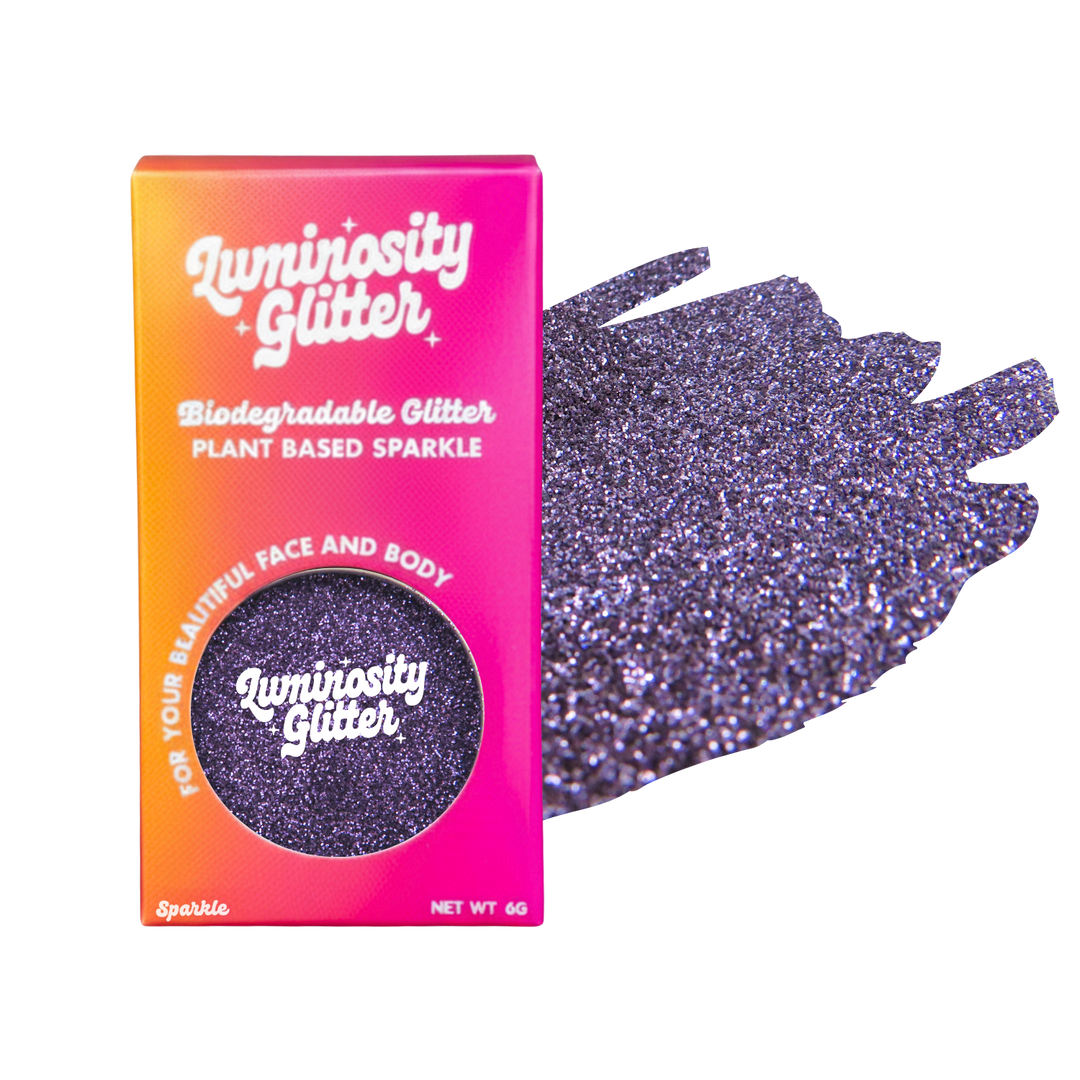 Luminosity Glitter packaging with purple glittery gloves on a white background