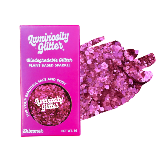 Pink glitter packaging with 'Luminosity Glitter' branding on a white background