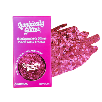 Pink glitter packaging with a sample of pink glitter on a white background