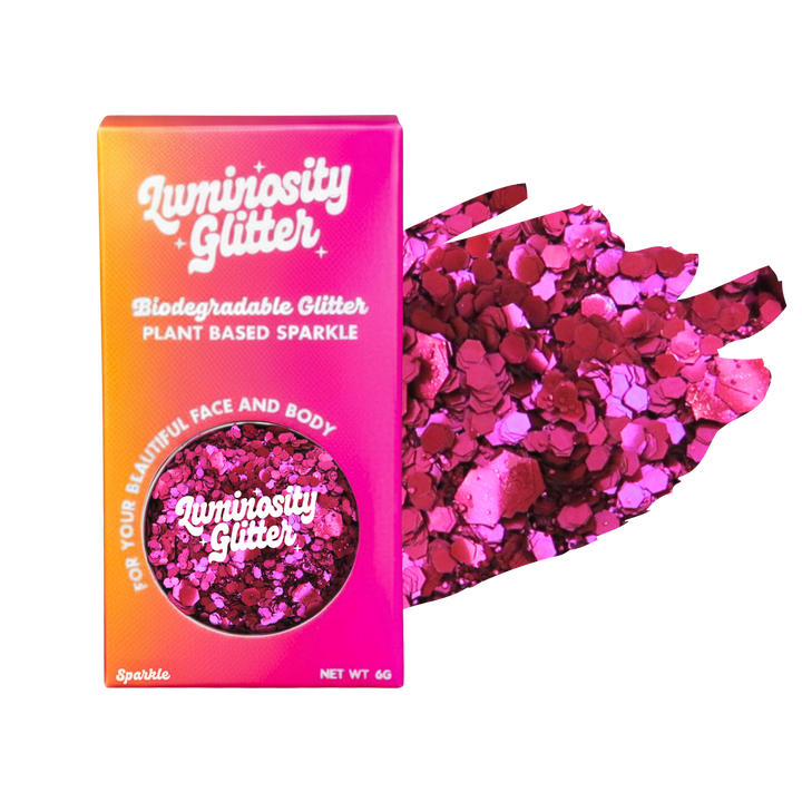 Luminosity Glitter packaging with pink and red glitter on a white background