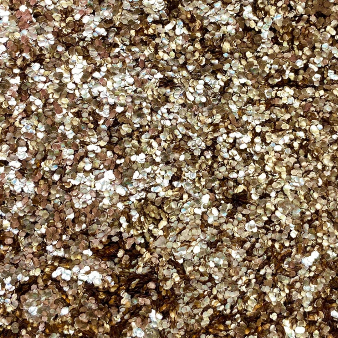 Close-up of rose gold chunky eco glitter showing the texture and reflective properties.