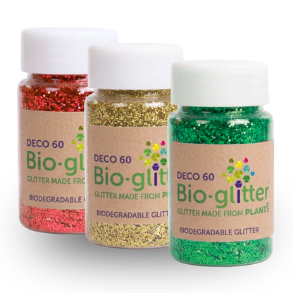 Three small jars of Bio-glitter by DECO 60 on a white background, showing red, gold, and green glitter. The labels read 'DECO 60 Bio-glitter GLITTER MADE FROM PLANTS' and 'BIODEGRADABLE GLITTER'.