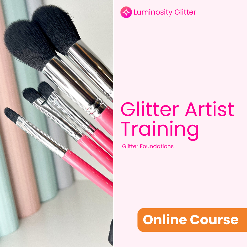 Makeup brushes with pink handles and black bristles, Luminosity Glitter branding on a white background.