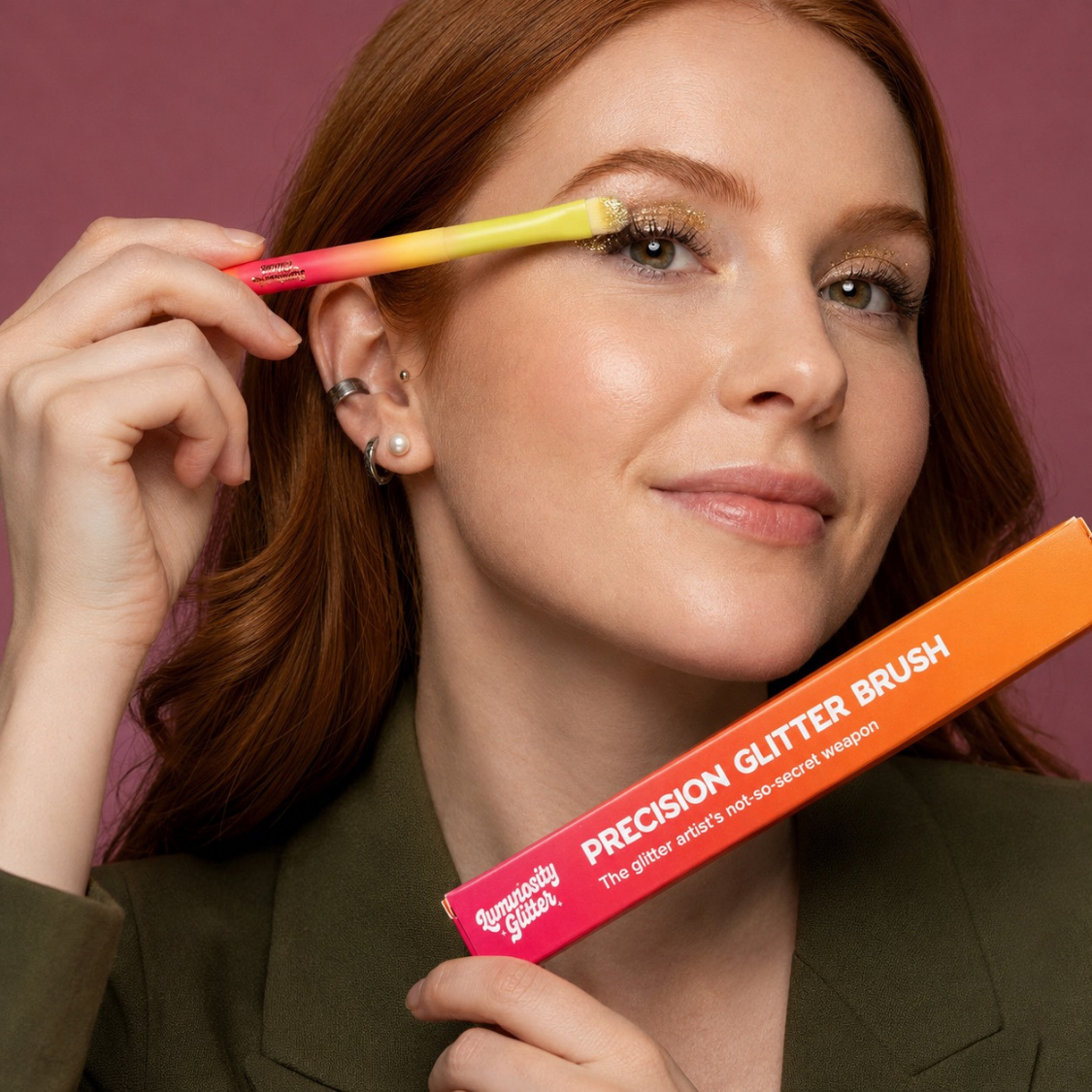 Woman applying makeup with a precision glitter brush against a purple background