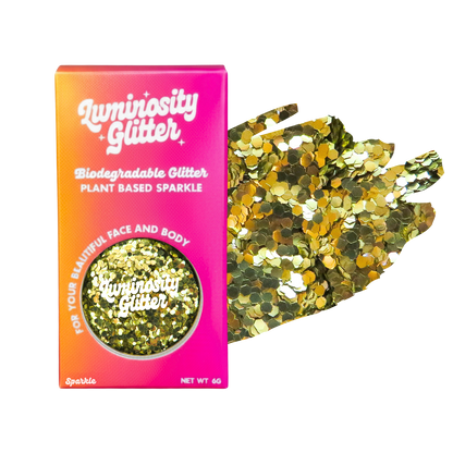 Luminosity Glitter packaging with gold glitter on a white background