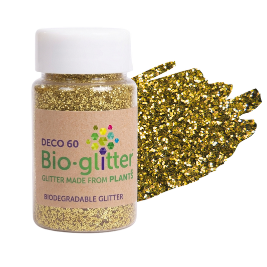 A bottle of craft Bio-glitter DEC0 60 biodegradable glitter with a white cap and kraft paper label, shown next to a textured gold glitter swatch on a white background.