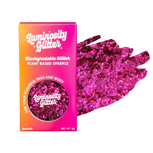 Luminosity Glitter packaging with pink glitter on a white background