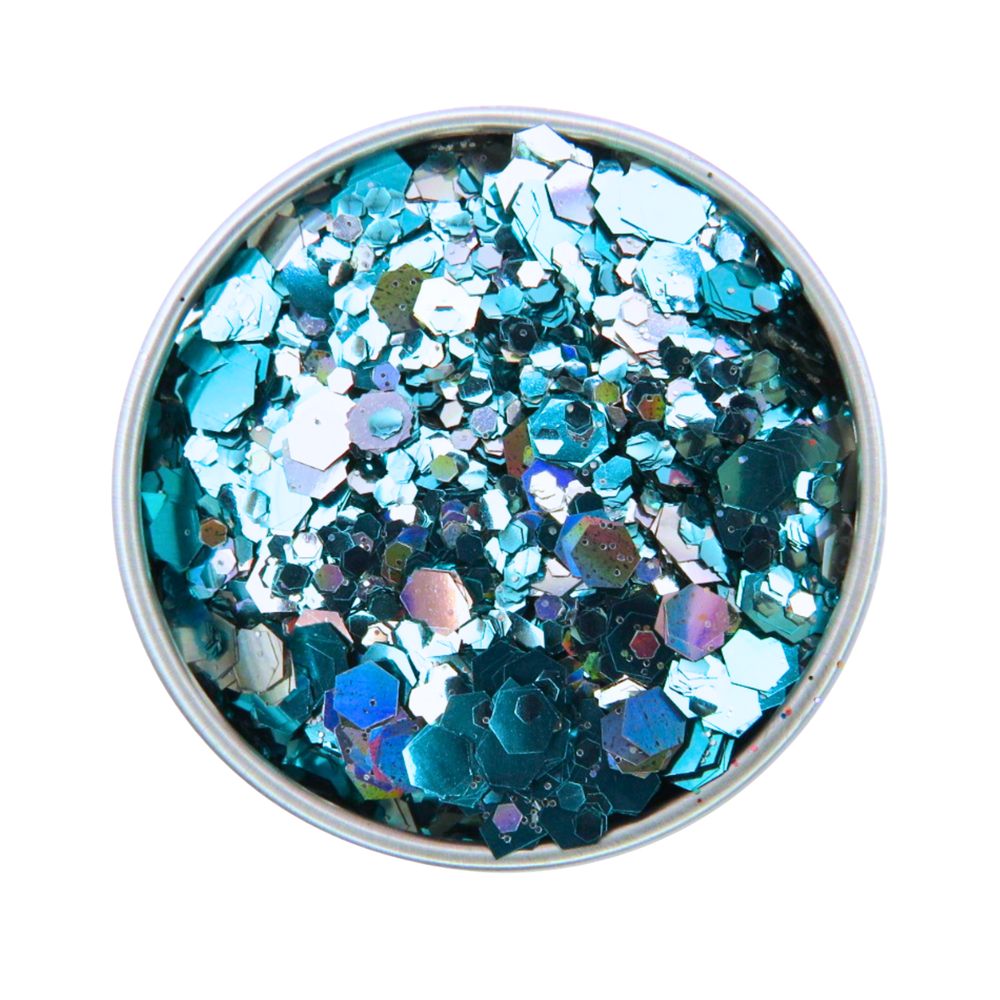 Metallic blue and silver glitter in a round container on a white background