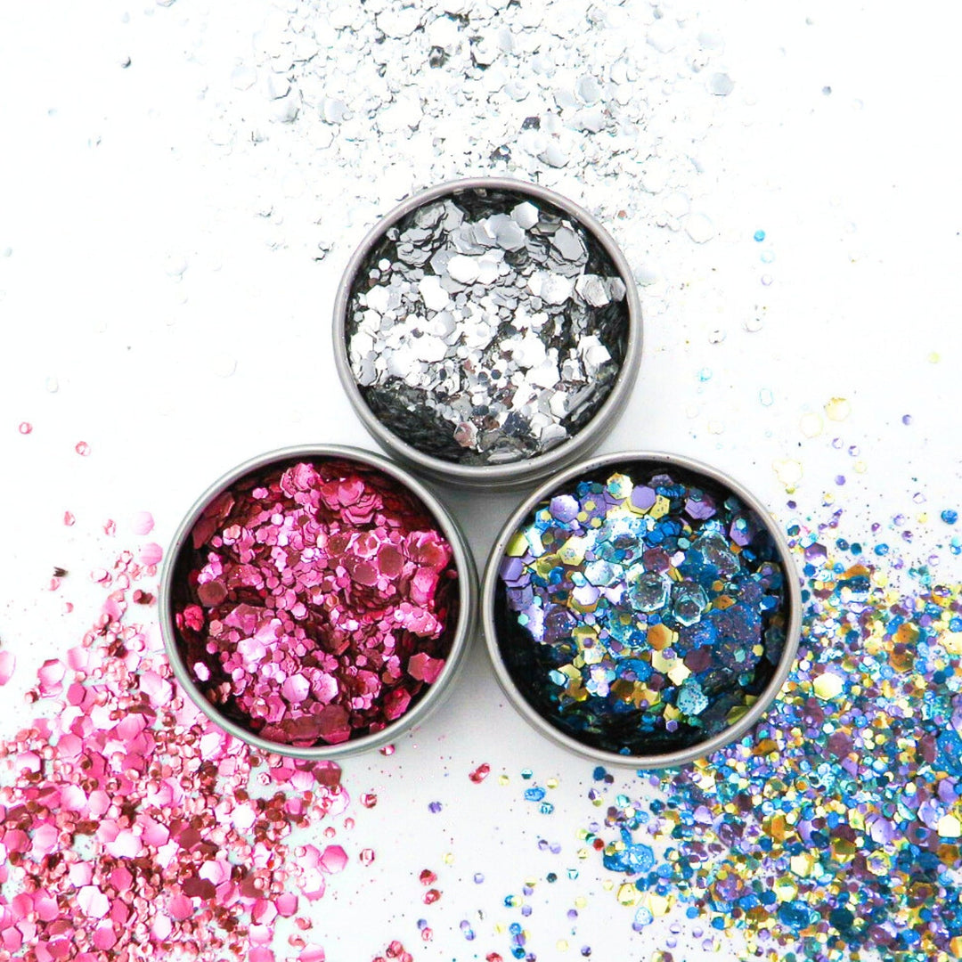 a trio of pots with silver, pink and multi coloured glitter in.