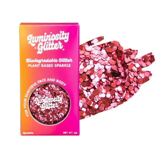 Luminosity Glitter packaging with pink and red glitter on a white background