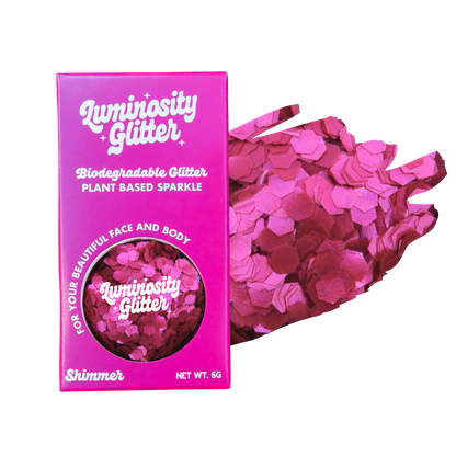 Pink glitter packaging with 'Luminosity Glitter' branding on a white background