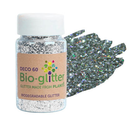 A jar of silver holographic craft Bio-glitter with a white cap and a brown paper label, shown next to a textured swatch of the glitter on a white background.